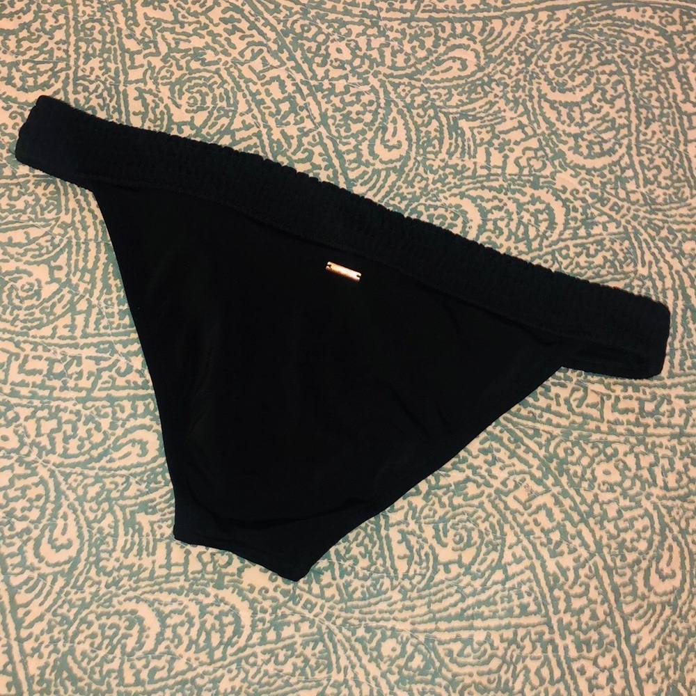 Low rise bikini bottom with rouched waistband.